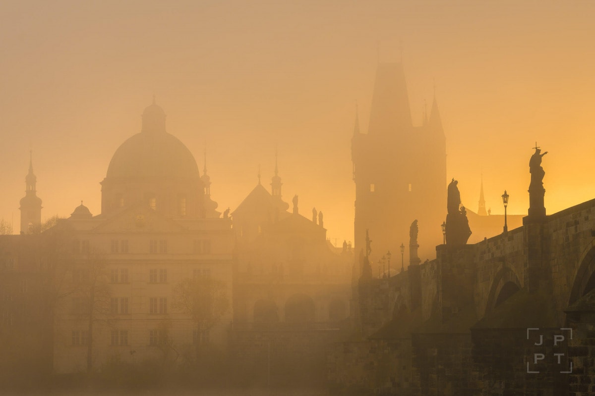 Charles bridge with mist at sunrise, Prague